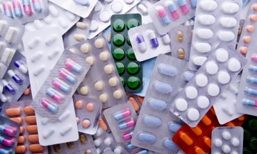 A pile of assorted medicine pill packets.