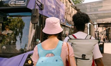 Two students walking to catch a bus