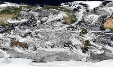 A satellite image-style world map with simulated cloud patterns. 