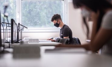Students socially distanced studying with masks on at desks. By John Cairns.