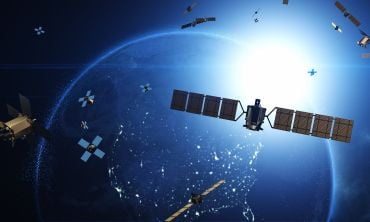Artistic graphic showing satellites and modular CubeSats in orbit over the Earth.