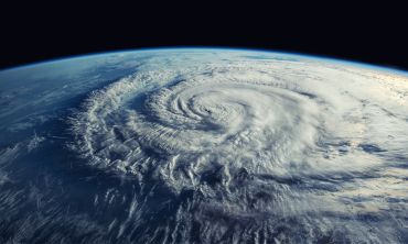 A satellite image of a cyclone forming above an ocean.