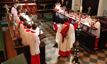 boys in robes singing in a church