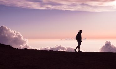 Person walking against a pinky sky | Jad Limcaco on Unsplash