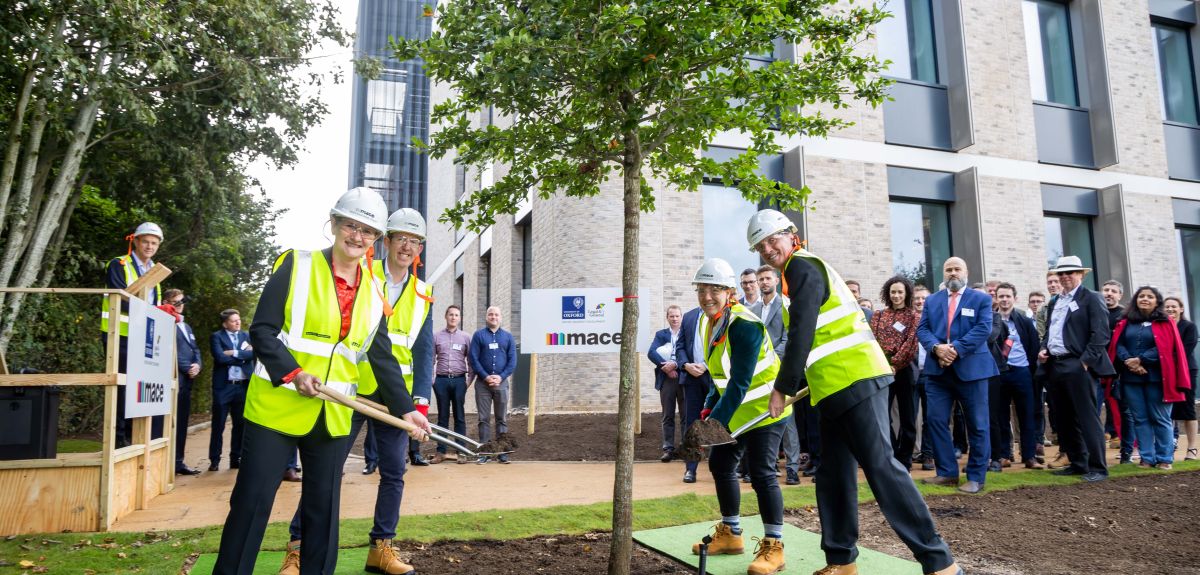 Image shows Professor Irene Tracey, Vice-Chancellor of the University of Oxford, about to shovel soil around a Nyssa sylvatica or black tupelo tree that has been planting at Begbroke Science Park