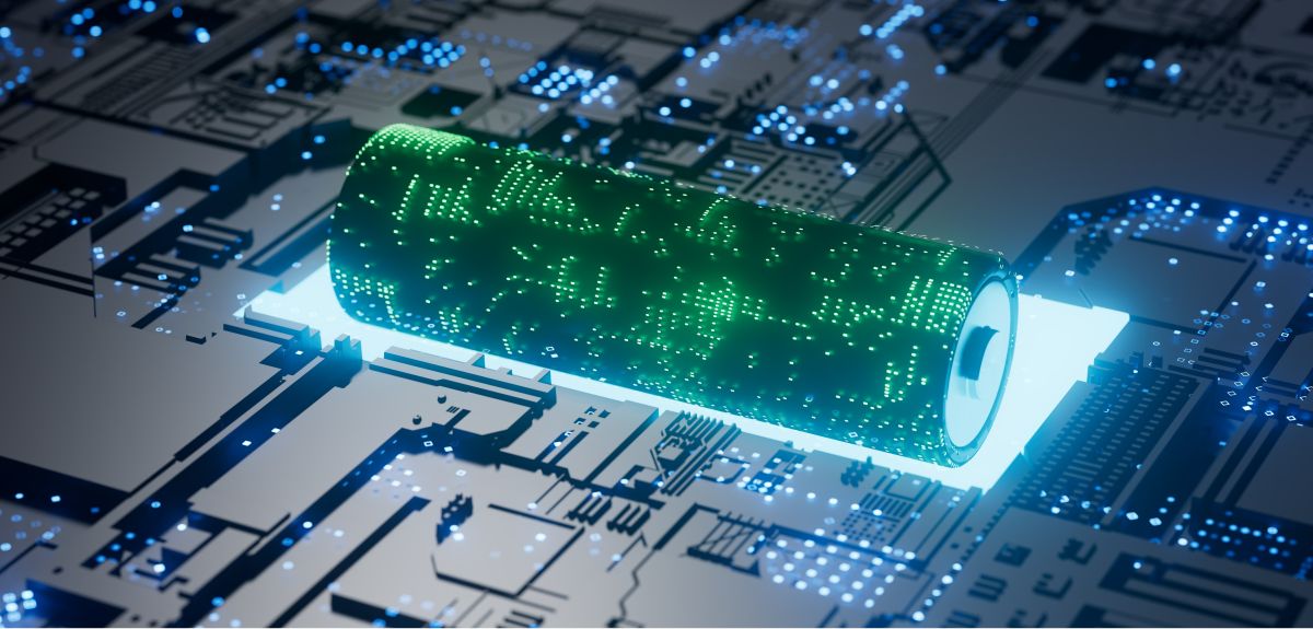 An artistic image of a glowing cylindrical battery lying on top of an electronic circuit board. Image credit: Shutterstock.