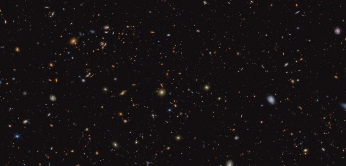 The image shows a deep galaxy field, featuring thousands of galaxies of various shapes and sizes.