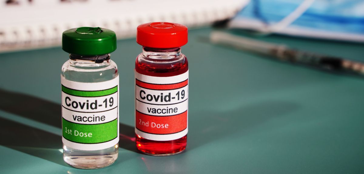 Mockup of two doses of a COVID-19 vaccine with needle