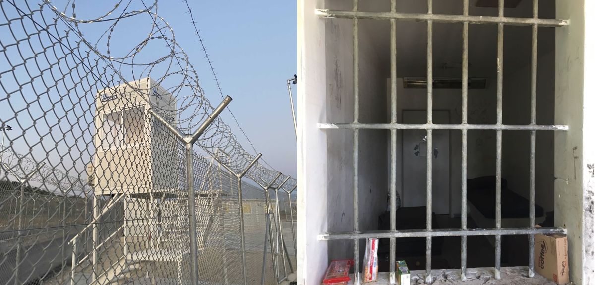 Left: A watch tower overlooking a barbed wire fence. Right: Looking inward through a barred window into a cell. A bed is visible and a door in the far wall.