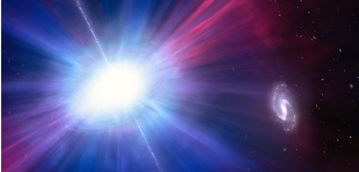An extremely bright explosion in outer space radiates white-hot light in all directions. A spiral galaxy is visible to the side.