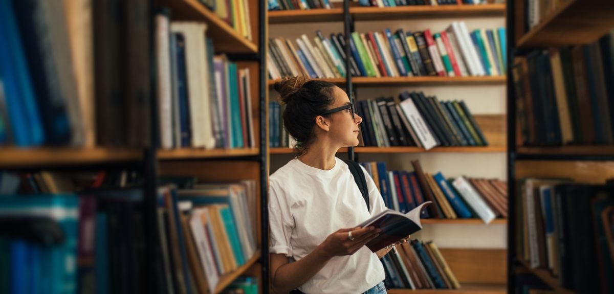 A student studying and reading books in a public library. Credit: Polina Lebed, Getty Images