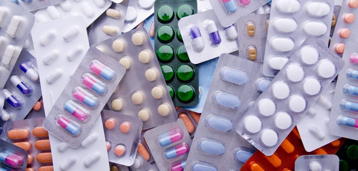 A pile of assorted medicine pill packets.