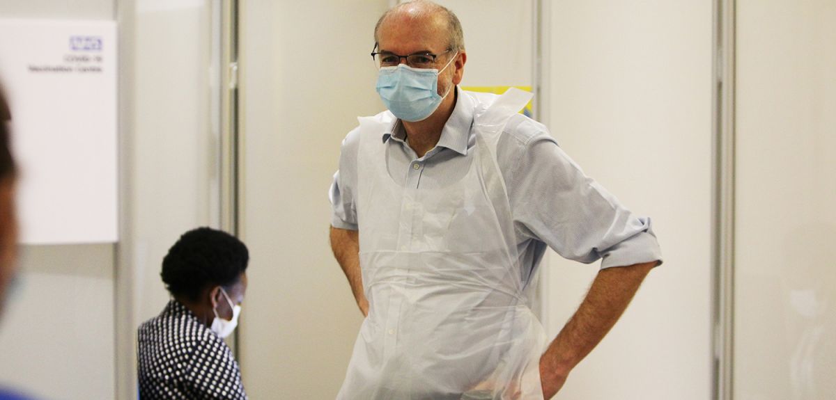 Photo | Prof. Pollard preparing to deliver coronavirus vaccinations at the Kassam Stadium (c) Oxford Health NHS Foundation Trust