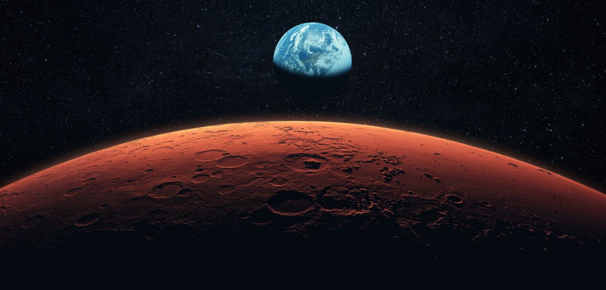 A view of the Earth in space, with the rim of the planet Mars in the foreground. Image credit: Shutterstock.