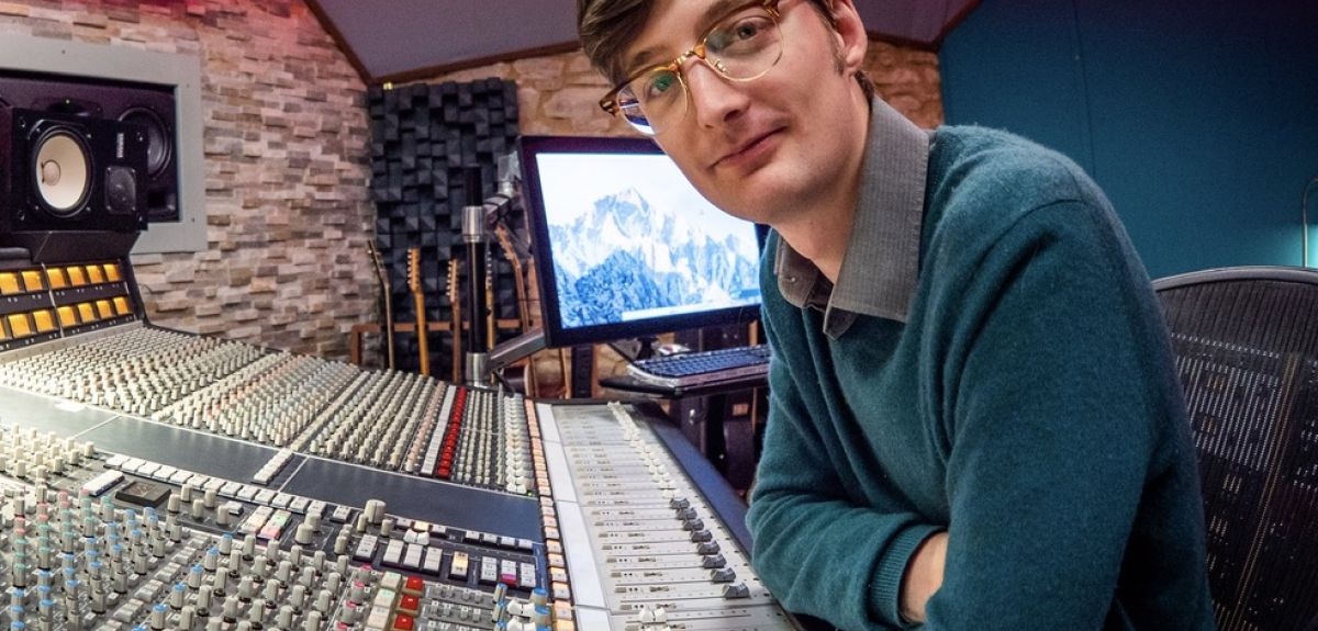 Student Matt Taylor at a recording studio desk.