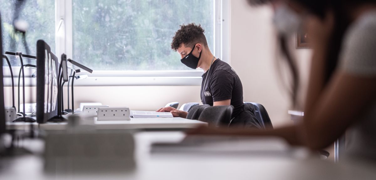 Students socially distanced studying with masks on at desks. By John Cairns.