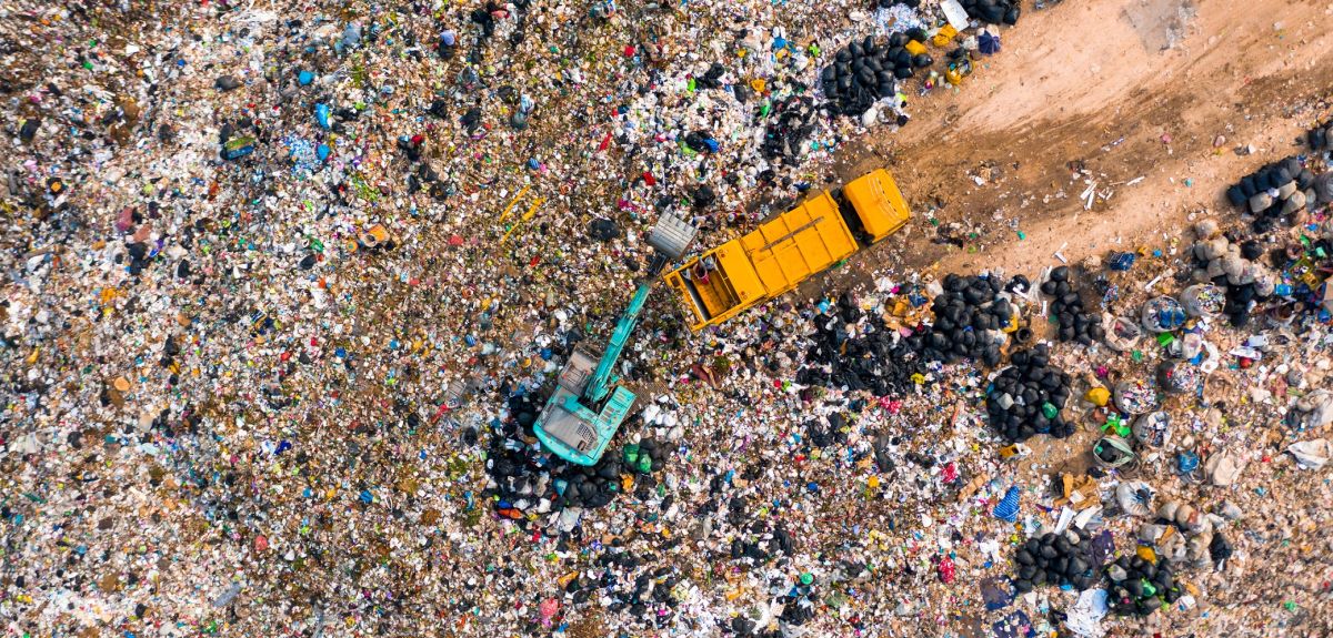 Aerial view of garbage trucks unloading garbage in a landfill.