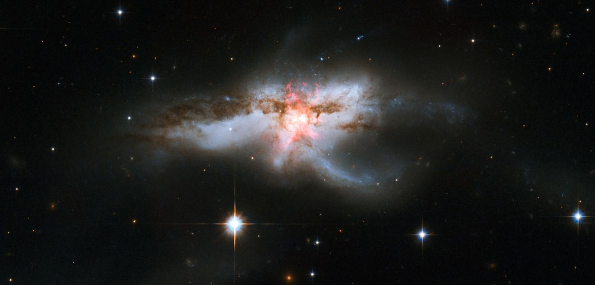 Image shows a galaxy where the star formation is obscured by large amounts of dust.