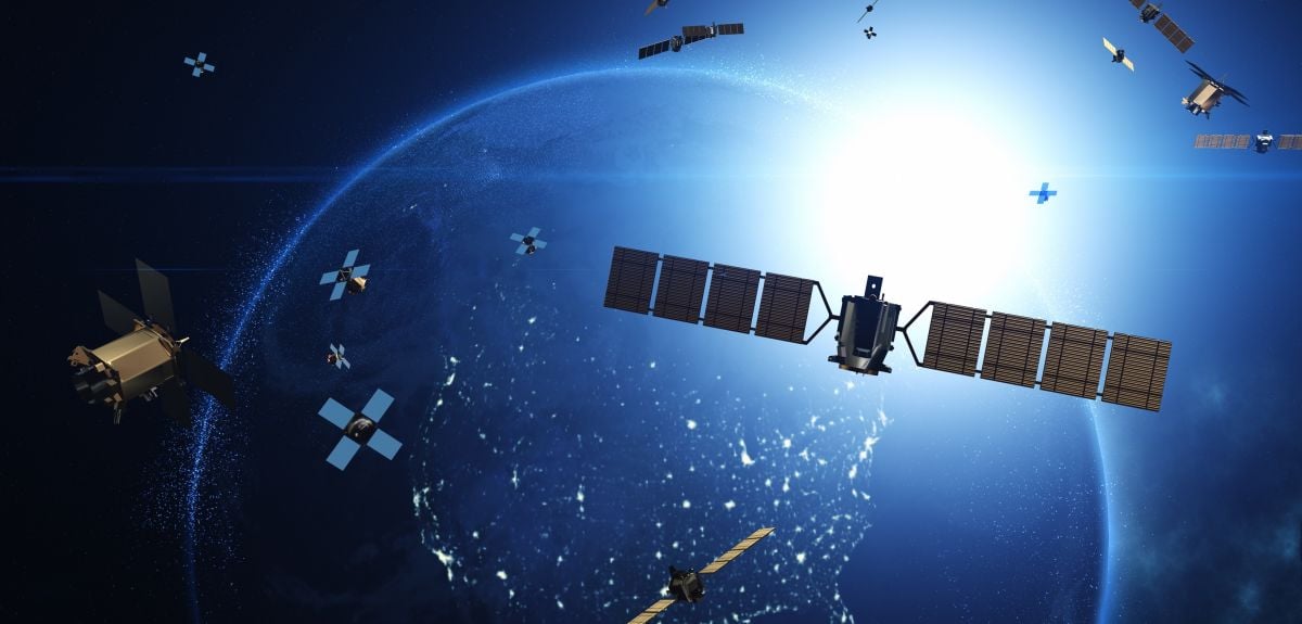 Artistic graphic showing satellites and modular CubeSats in orbit over the Earth.