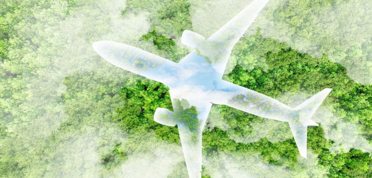 Artistic concept of an eco-friendly plane with an outline of blue sky and clouds, flying over a forest.