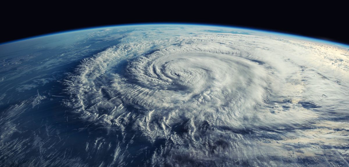A satellite image of a cyclone forming above an ocean.