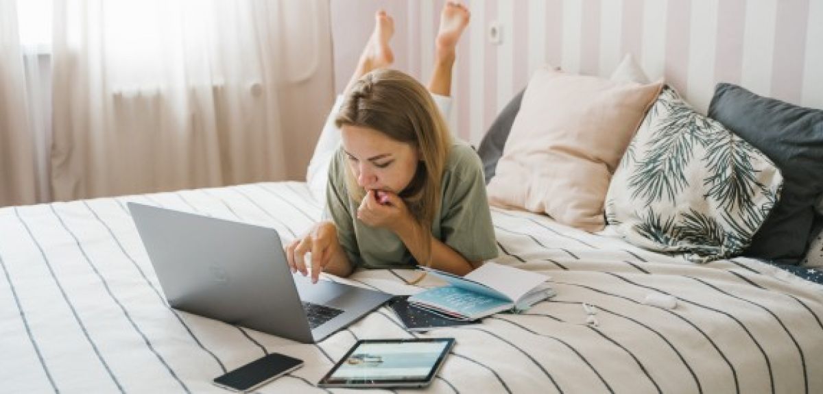 Person on their laptop while laying on their bed. Credits: Tima Miroshnichenko via Pexels