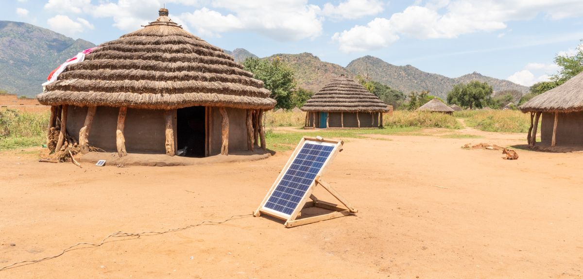 Solar panel providing electricity to dwellings in rural Africa