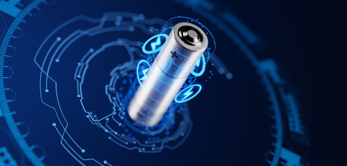 An abstract image showing a close up of a battery surrounded by digital projections of energy and manufacturing symbols. 