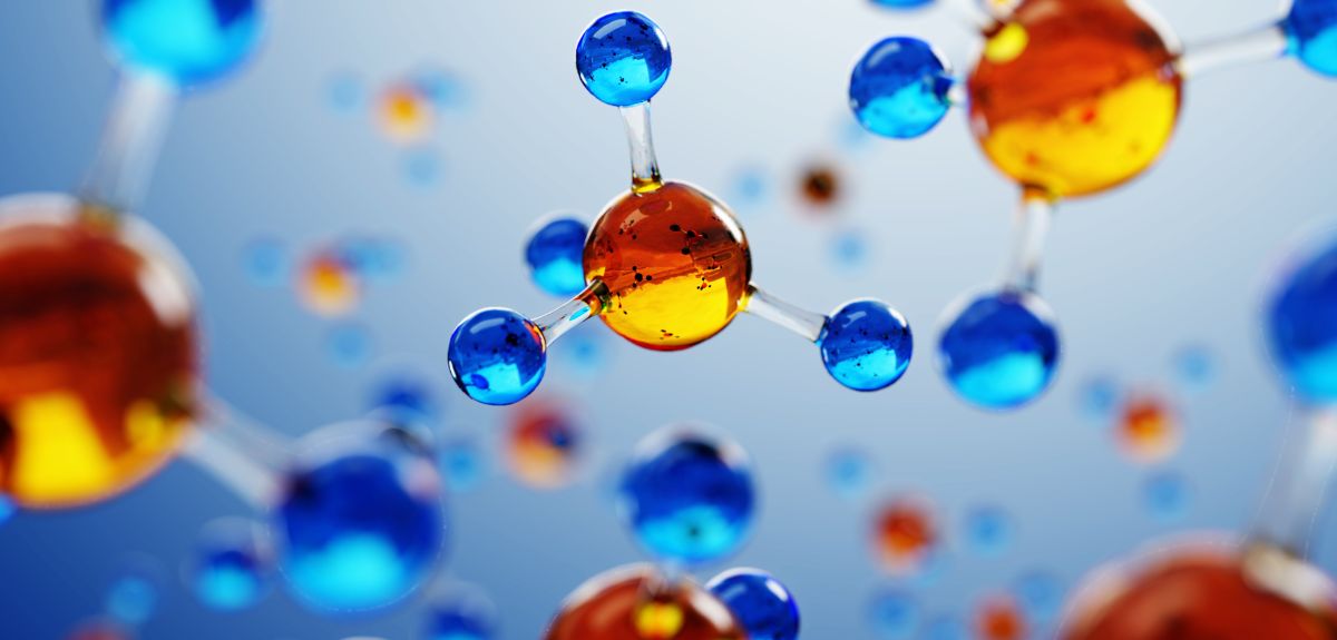 An artistic image of molecules made of a central sphere connected to four smaller spheres. Image credit: Shutterstock.