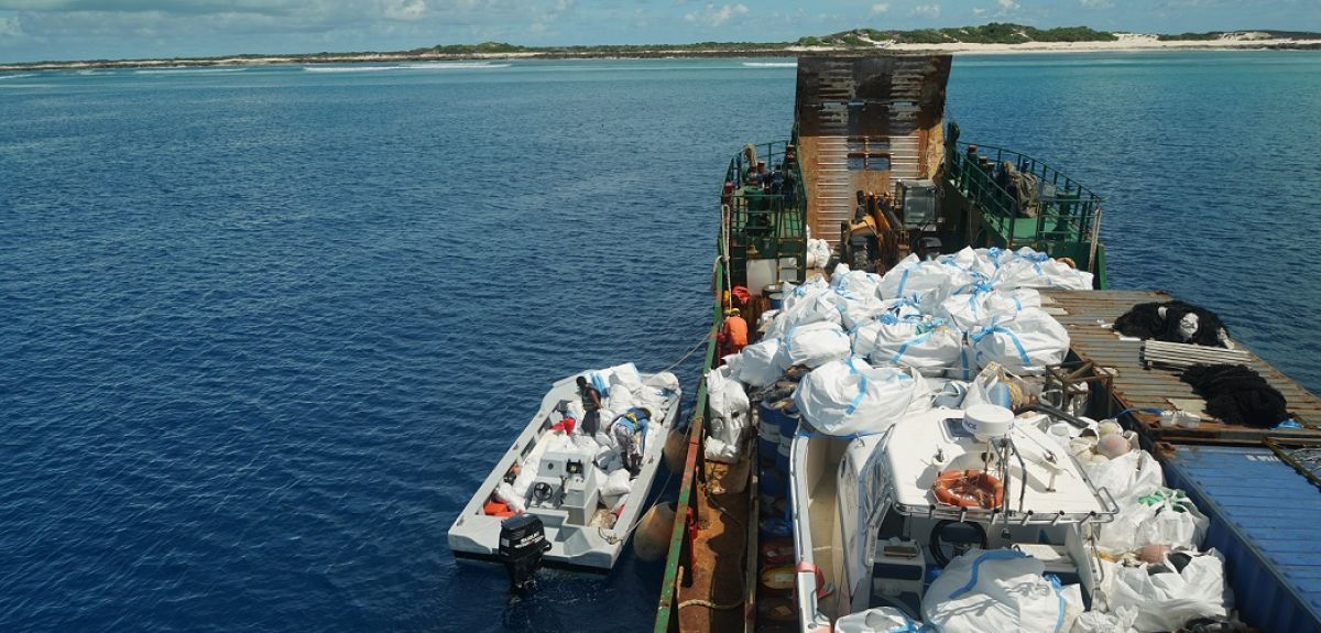 Boat collecting waste from Aldabra