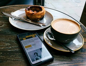 Coffee and pastry on cafe table