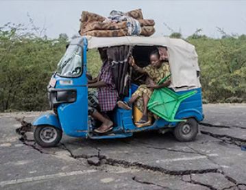 Tuk tuk and damaged road