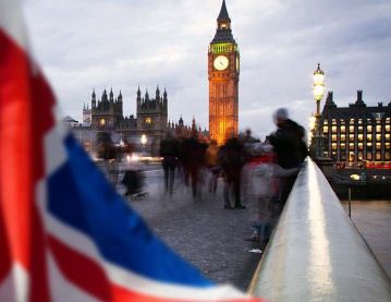 A photograph of the British union jack flag, Big Ben Clock Tower and Parliament house 