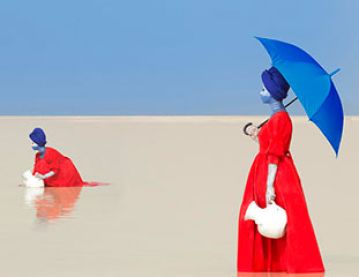 women in red dresses and blue umbrellas
