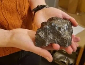Woman holding a meteorite