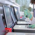 Scientist pipetting onto a GridION in a Nanopore lab
