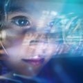 Close up of a little girl looking at some futuristic holograms.