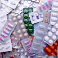 A pile of assorted medicine pill packets.