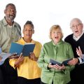 Four senior adults singing