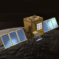 A spacecraft shaped like a box with two arms in orbit above the Moon's surface.