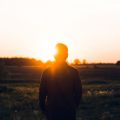 Person stood in front of a sunrise. Photo by Warren Wong on Unsplash