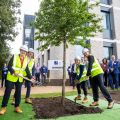 Image shows Professor Irene Tracey, Vice-Chancellor of the University of Oxford, about to shovel soil around a tree that has been planting at Begbroke Science Park