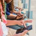 Teens use mobile phones outside. Credit: FG Trade Latin, Getty Images