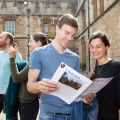 Image of visitors to Oxford Open Doors at St John's College with a guide book ready to explore