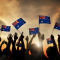 Crowd of people holding mini Australia flags