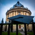 Image of a mortar board hanging on the railings outside Radcliffe Camera